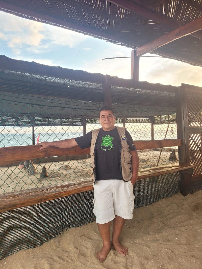 Hugo Ibañez and one of the corrals used to protect the turtle eggs. 