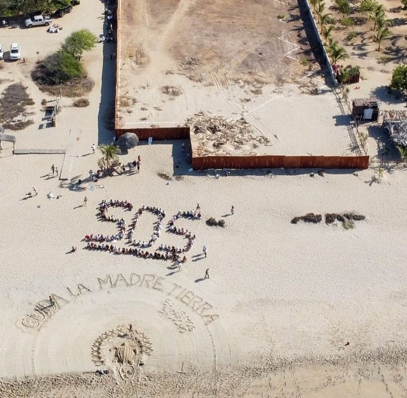 An SOS message on the beach at the site of the Oxean development.